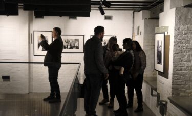 Ludzie oglądający wystawę i robiący zdjęcia